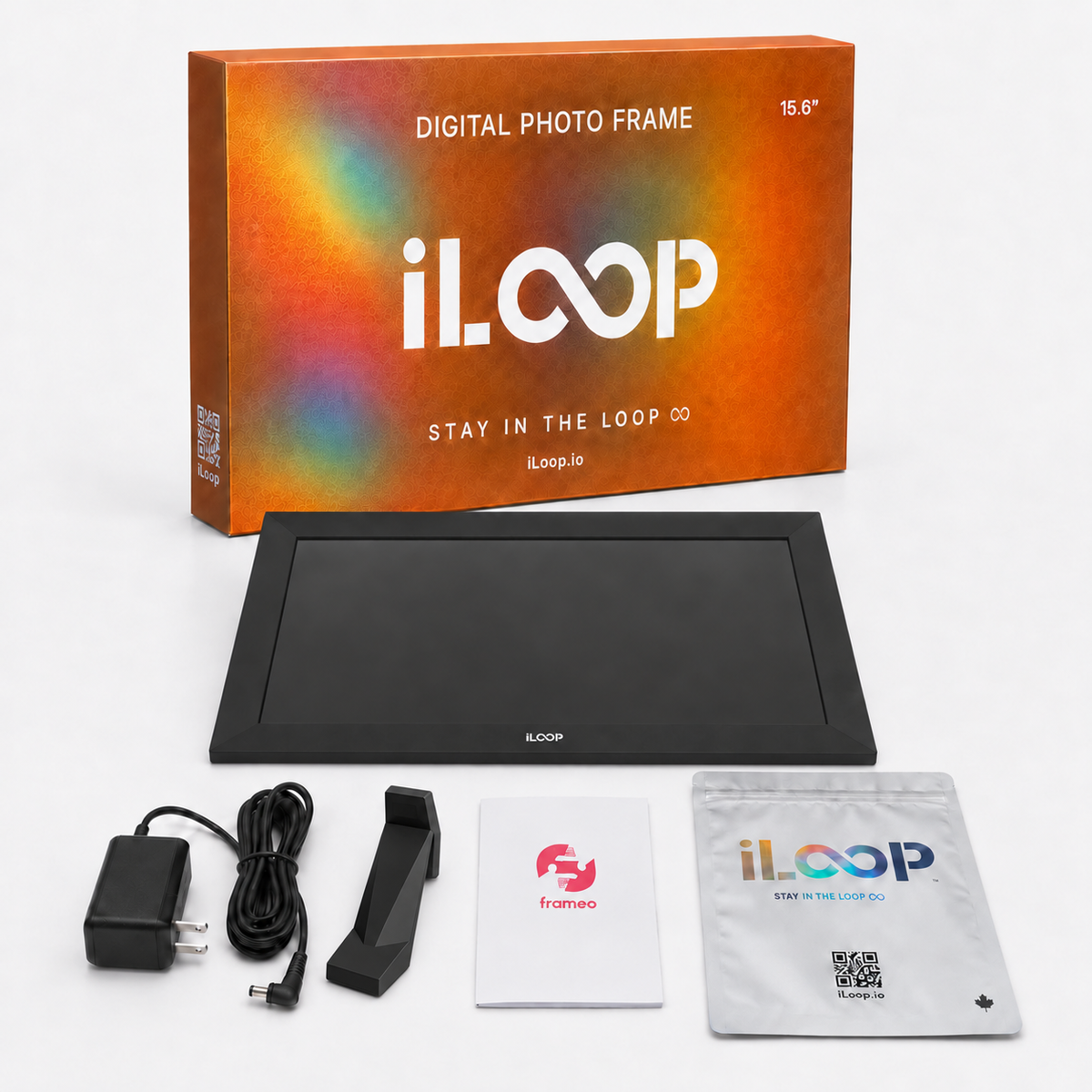 iLoop digital photo frame kit with a 15.6-inch black frame, retail box, power adapter, cable, mounting bracket, quick start guide, and warranty card on a white background.