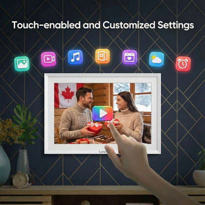 Smart photo frame displaying a couple with a hand touching it, against a dark blue wall with decorative elements. iloop 15.6” Digital Photo Frame | WiFi Touch Screen, 32 GB | Frameo App | Tabletop or Wall-Mounted